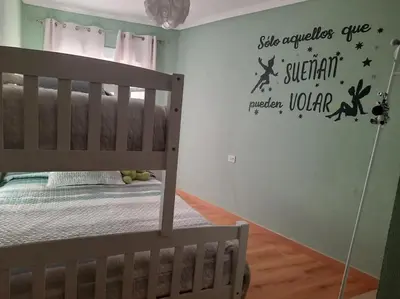 a childs room with a crib with a bunk bed at Casa Daló II in Folgoso