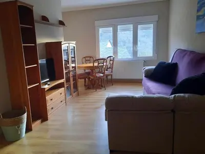 a living room with a couch and a table at Casa Daló II in Folgoso