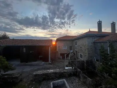 a view of two buildings with the sunset in the background at Refuxio Da Mina in Leborey
