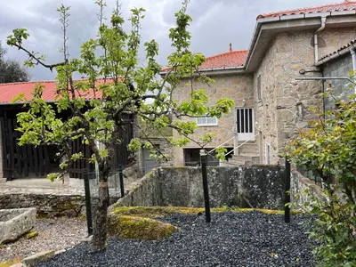 a group of trees in front of a building at Refuxio Da Mina in Leborey
