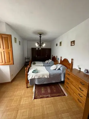 a bedroom with a bed and a dresser in it at Refuxio Da Mina in Leborey