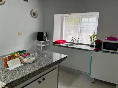 a kitchen with a counter top and a sink at Refuxio Da Mina in Leborey