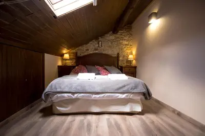 a bedroom with a bed with two towels on it at La Casona de Sarria in Sarria
