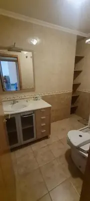 a bathroom with a sink and a toilet and a mirror at Ribeiras do Tamega in Verín
