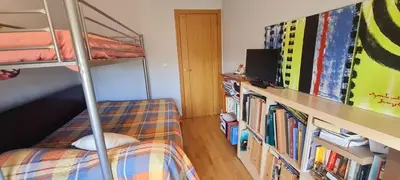 a bedroom with a bunk bed and a book shelf with books at Ribeiras do Tamega in Verín