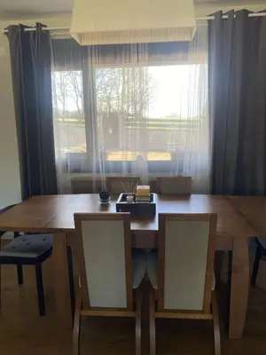 a dining room table with two chairs and a window at Casa do alpendre in Ourense
