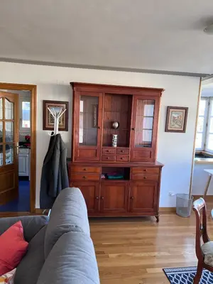 a living room with a large wooden cabinet at Casa la Plaza in Molinaseca