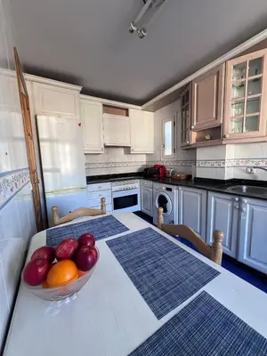 a kitchen with a bowl of fruit on a table at Casa la Plaza in Molinaseca