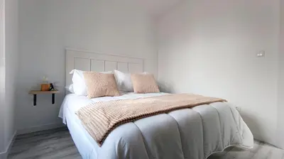 a white bed with two pillows on top of it at Casa Rectoral de Rante in Rante