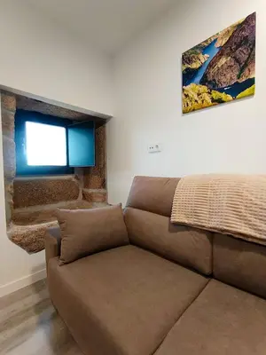 a living room with a couch and a window at Casa Rectoral de Rante in Rante