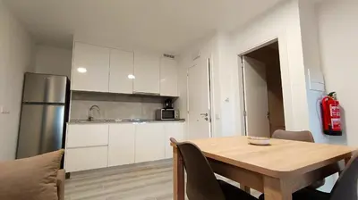 a kitchen with a wooden table and a refrigerator at Casa Rectoral de Rante in Rante