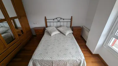 a bedroom with a bed with two pillows on it at Alojamiento La Caridad in La Caridad