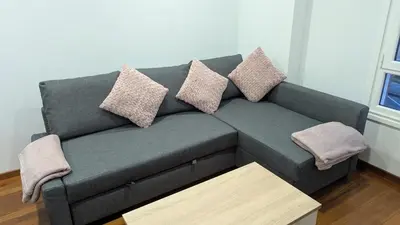 a couch in a living room with pillows on it at Alojamiento La Caridad in La Caridad