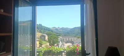 a window with a view of a town at Alojamiento Turístico Santalla in Santa Eulalia de Oscos