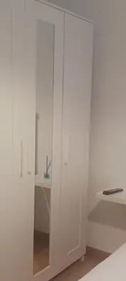 a white cabinet with a mirror in a room at Alojamiento Turístico Santalla in Santa Eulalia de Oscos