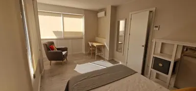 a bedroom with a bed and a desk and a chair at Abacería in Allariz