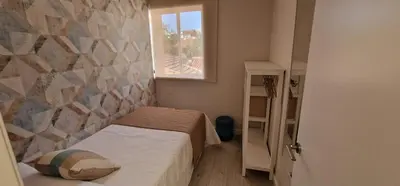 a small room with a bed and a window at Abacería in Allariz