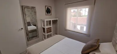 a bedroom with a bed and a window and a mirror at Abacería in Allariz
