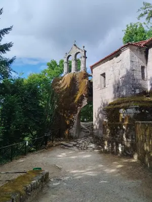 an old building with a church on top of a rock at A Feitiña de Rubiacós in Rubiacós