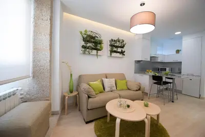 a living room with a couch and a table at Bolboreta Apartments by Como en Casa in Santiago de Compostela