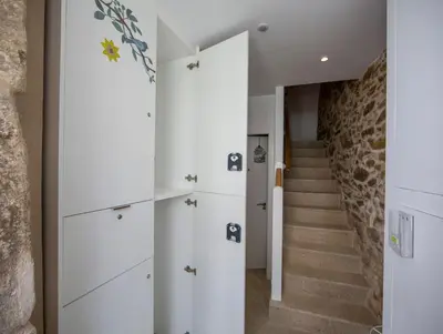 a room with white cabinets and a staircase at Bolboreta Apartments by Como en Casa in Santiago de Compostela