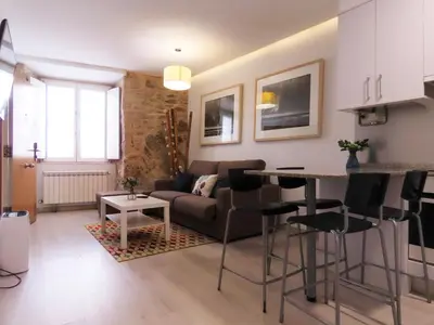 a living room with a couch and a table at Bolboreta Apartments by Como en Casa in Santiago de Compostela