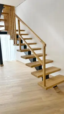 a wooden staircase in a room with wooden floors at Gallaecia Dúplex in Arzúa