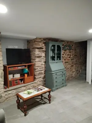 a living room with a green cabinet and a table at Casa Engracia in Arcos