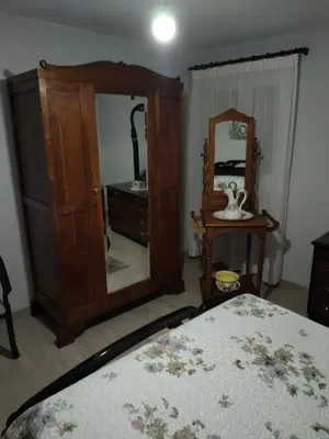 a bedroom with a dresser and a mirror and a bed at Casa Engracia in Arcos