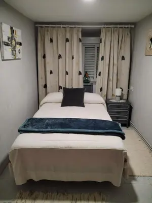 a bedroom with a large bed with a black pillow on it at Casa Engracia in Arcos