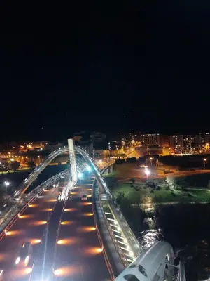 a large white bridge at night with cars at YourHouse Ourense Bello 2 Loft in Ourense