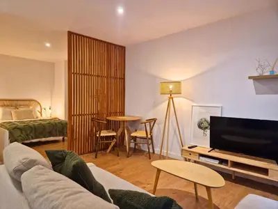 a mirror on a wall above a table with a vase at YourHouse Ourense Bello 2 Loft in Ourense
