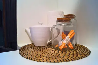 a glass jar with carrots in it next to a vase at YourHouse Ourense Bello 1 Loft in Ourense
