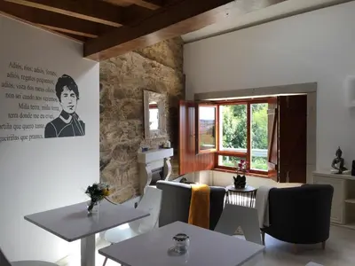 a dining room with two tables and a window at Casa Juancito in Santiago de Compostela