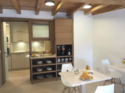 a kitchen and dining room with a table and chairs at Casa Juancito in Santiago de Compostela