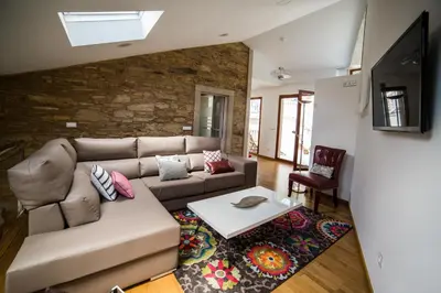 a living room with a couch and a table at Casa Juancito in Santiago de Compostela