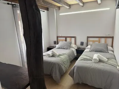 a bedroom with two beds with towels on them at Casa Lounge Xacobeo in Tríacastela