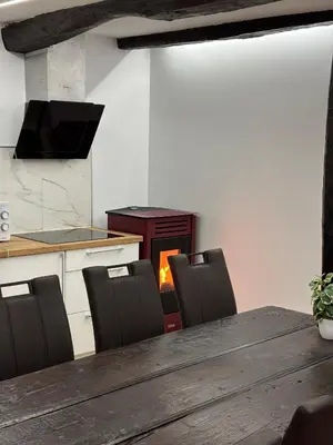 a kitchen with a table and chairs and a stove at Casa Lounge Xacobeo in Tríacastela