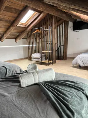 a bedroom with a bed with a towel on it at Casa Lounge Xacobeo in Tríacastela