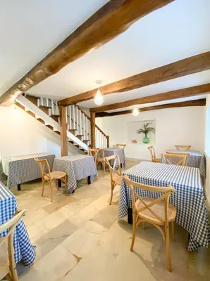 a dining room with tables and chairs and a staircase at Casa Pastur in Serantes