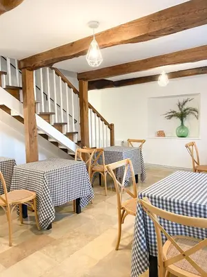 a restaurant with tables and chairs and a staircase at Casa Pastur in Serantes