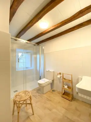 a bathroom with a toilet and a sink and a stool at Casa Pastur in Serantes