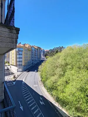 a view from a balcony of a road with buildings at Apartamento Ó Xeitoso Milladoiro in Milladoiro