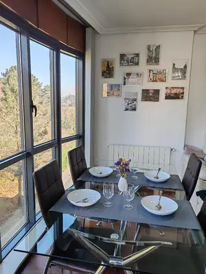 a dining room with a table and chairs at Apartamento Ó Xeitoso Milladoiro in Milladoiro