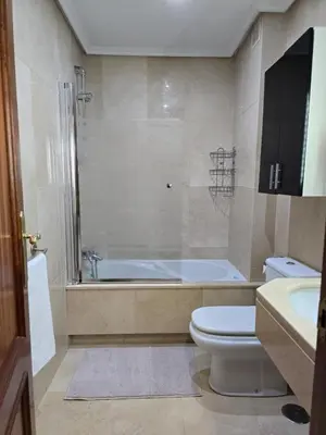 a bathroom with a tub and a toilet and a sink at Apartamento Ó Xeitoso Milladoiro in Milladoiro