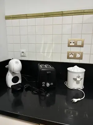 a black counter top with a toaster and a blender at Apartamento Ó Xeitoso Milladoiro in Milladoiro