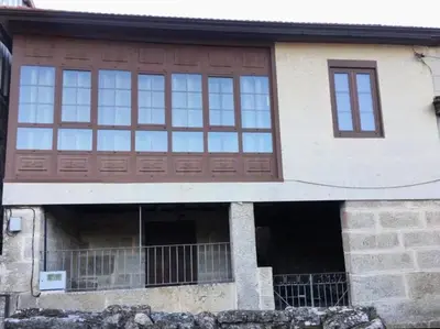 a house with a wooden door and windows at Casa Rural Melon in Melón