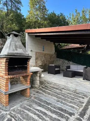 an outdoor brick oven with a table and benches at Casa Rural Melon in Melón