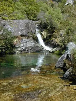 a waterfall in the middle of a river at Casa Rural Melon in Melón