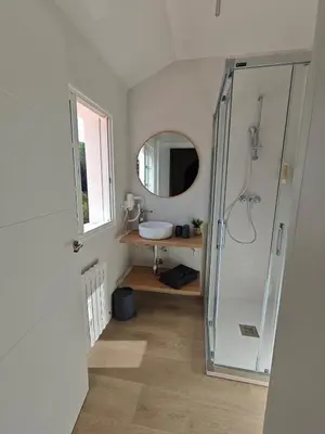 a room with a chair and a rug and a window at Villa Vieira in A Escravitude